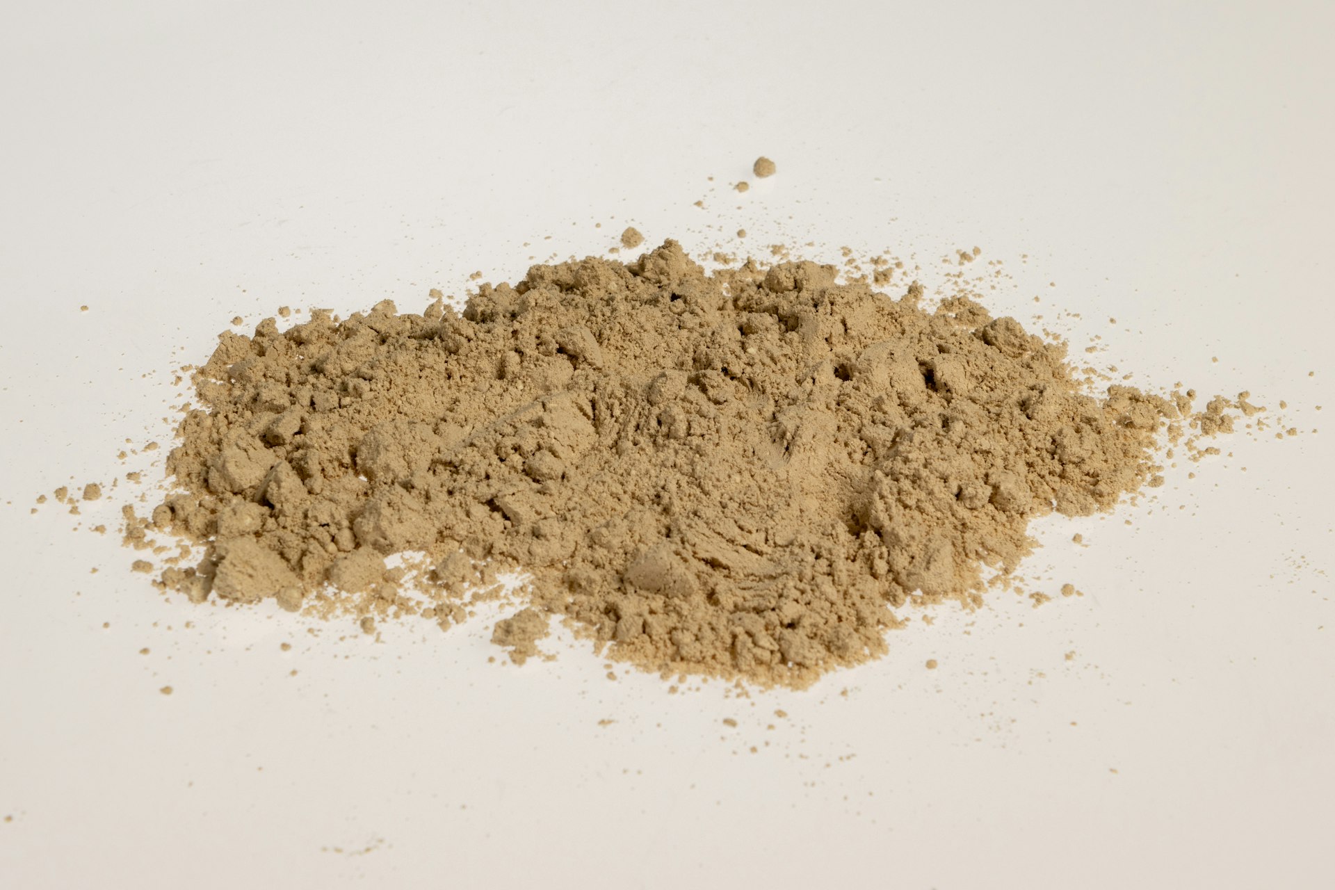 a pile of dirt sitting on top of a white table